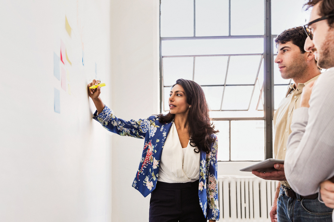 Woman speaking to team during strategy session