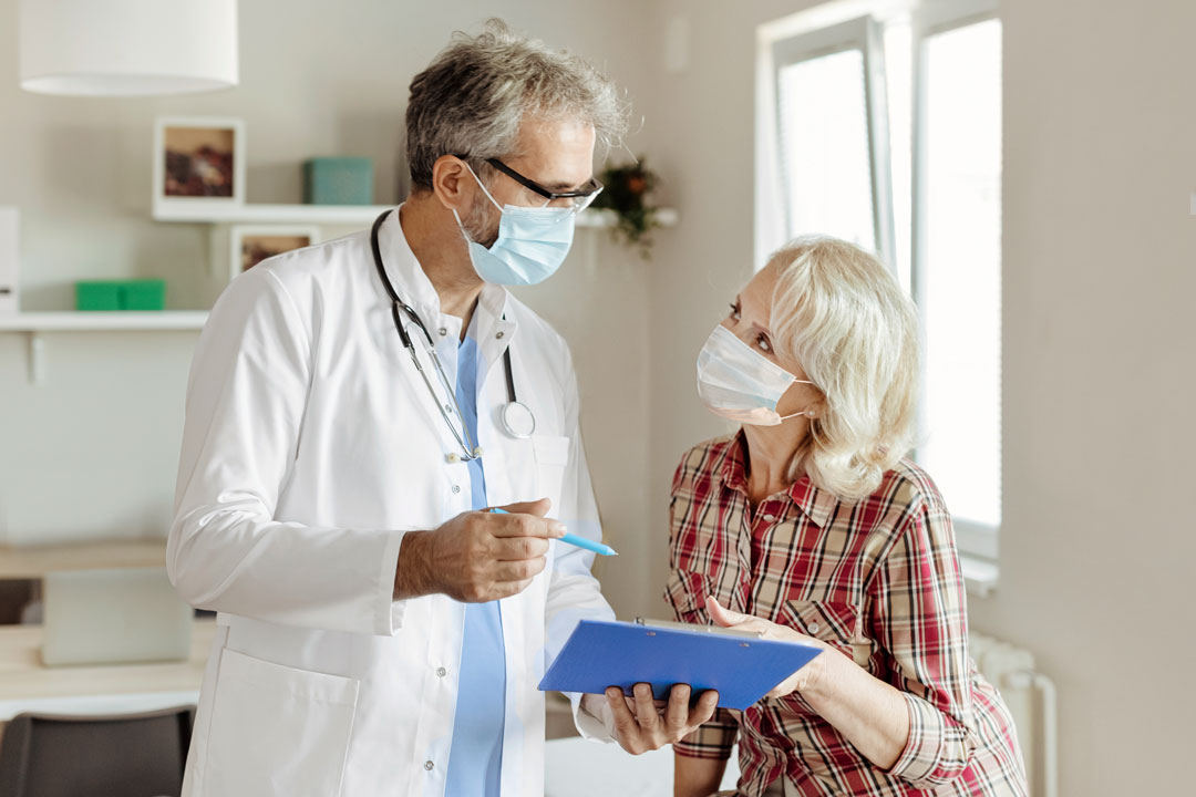 Male doctor and female patient in a clinical setting